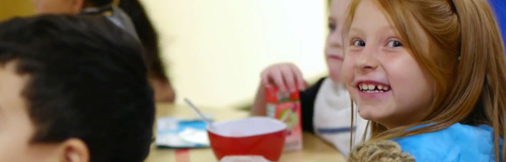 girl smiling at lunch table