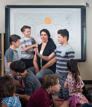 Teacher with students signing to each other